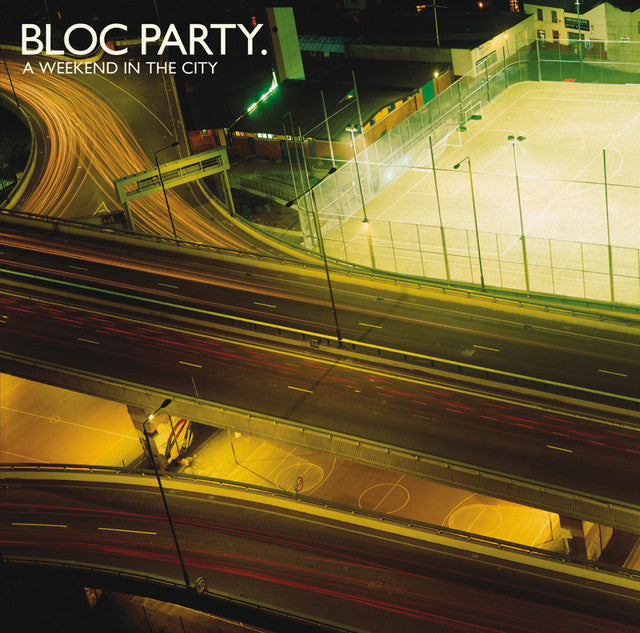 Highway at night with sports fields and 'BLOC PARTY' text