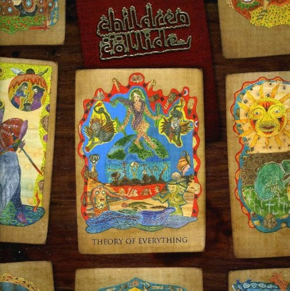 Collection of colorful tarot cards with intricate designs on a wooden surface.