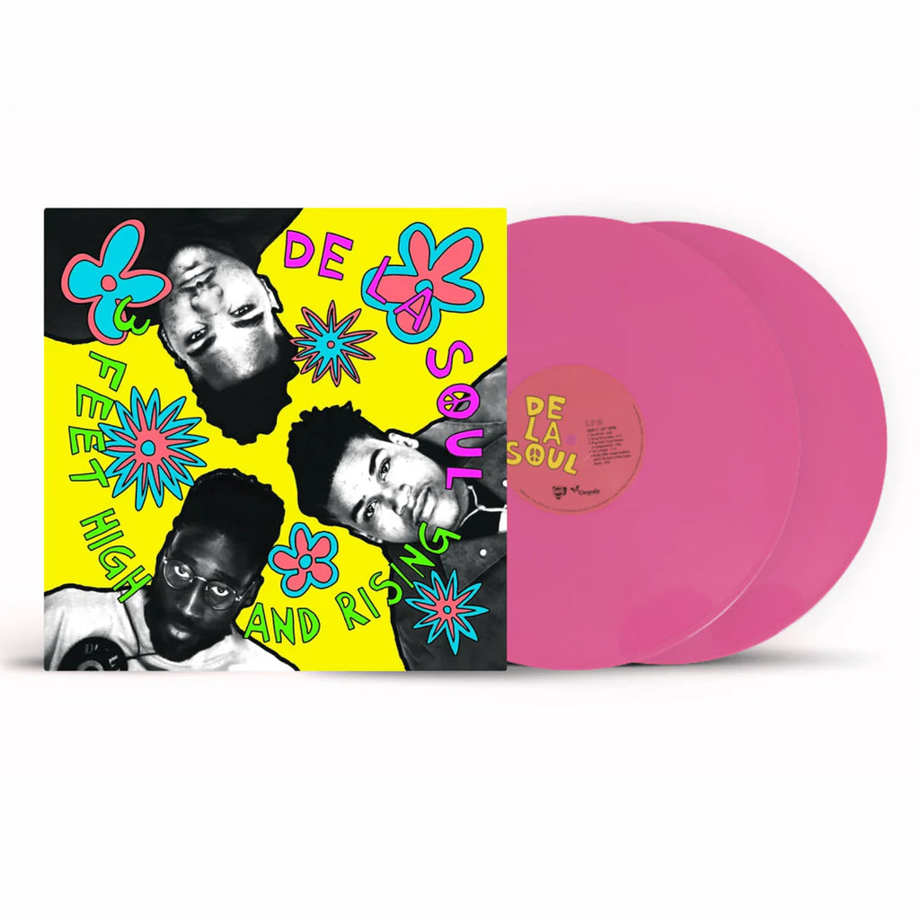 Vinyl record with colorful cover featuring faces and flowers, pink disc on a white background