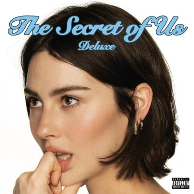 Album cover with a person's face and 'The Secret of Us Deluxe' text.