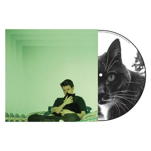 Vinyl record album cover with a green-toned photo of a man holding a black cat, alongside a black-and-white cat-print record on a white background.
