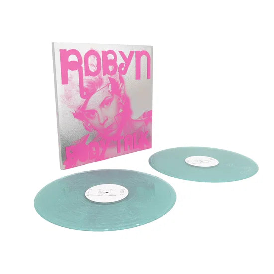 Vinyl records with a pink and white album cover featuring a portrait.