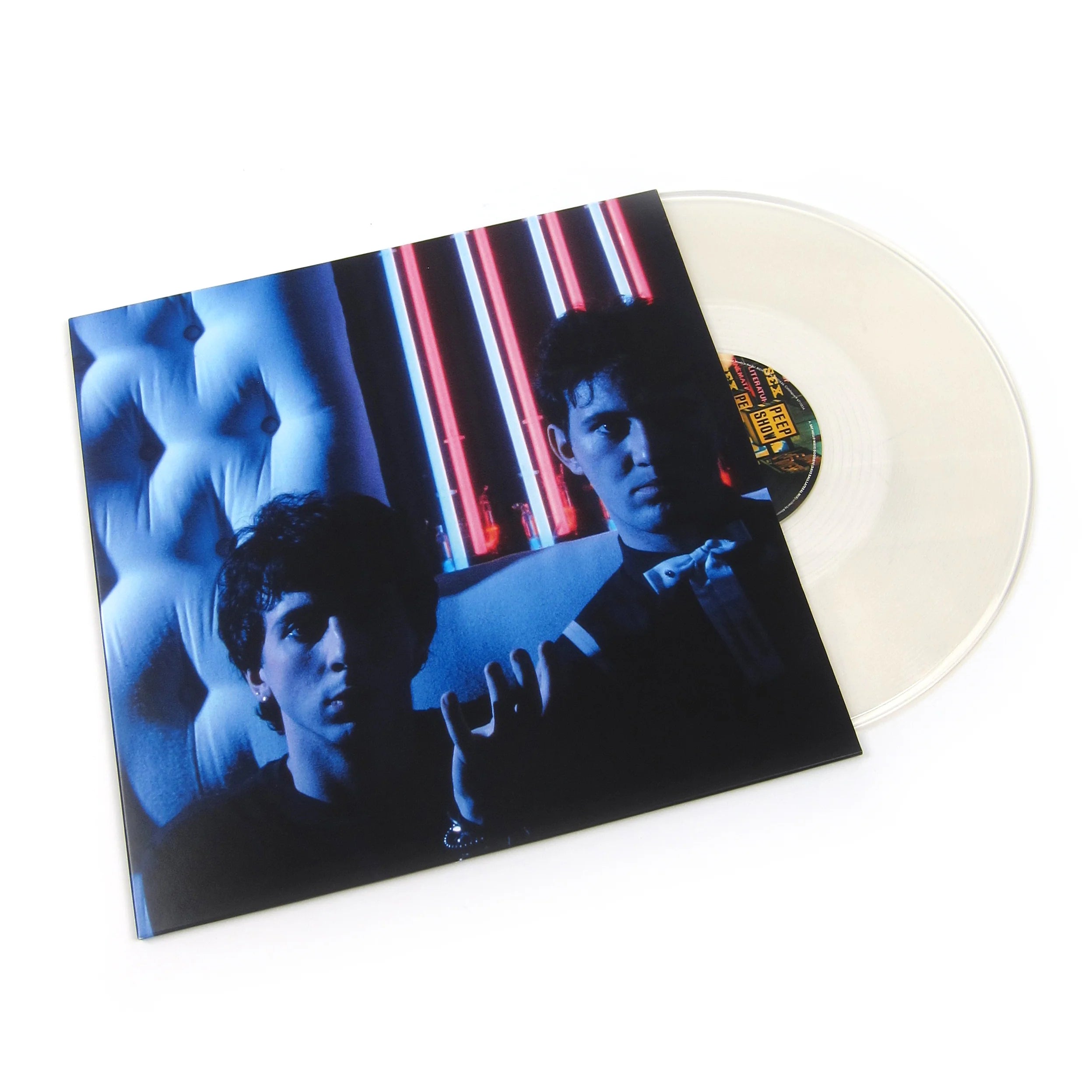 Clear vinyl record partially removed from sleeve showing Say Hello, Wave Goodbye / Youth by Soft Cell, featuring a blue-toned portrait of the duo with neon red and blue lights behind them.