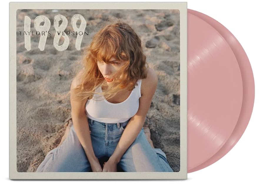 Vinyl record with a cover featuring a person on a beach and '1989 Taylor's Version' text.
