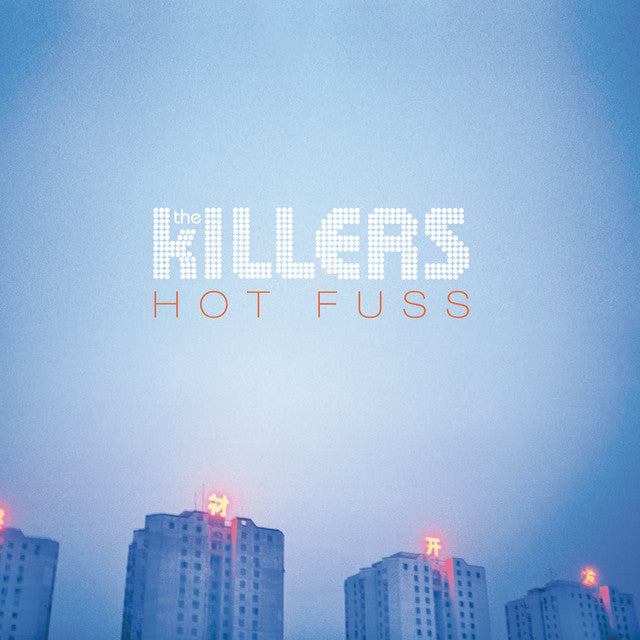 Album cover for 'Hot Fuss' by The Killers with city skyline in the background.