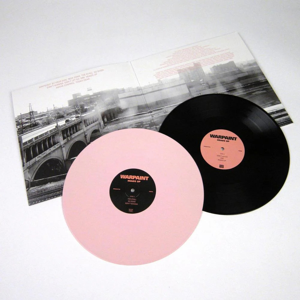 Two vinyl records with pink and black color scheme on a white background